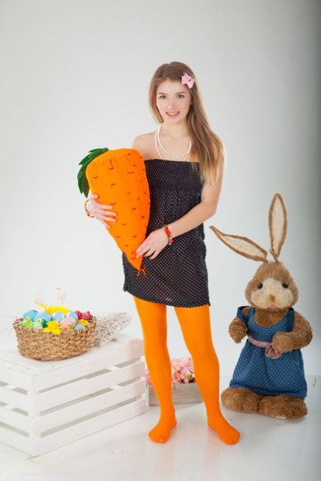 Sweet teen Verona doffs a black dress and orange hose for a nude solo shoot