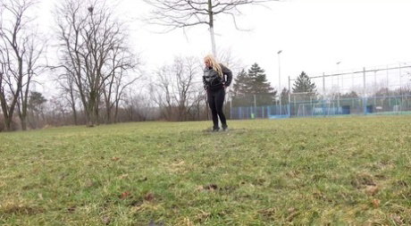 Blonde girl Henriet gets caught taking a piss while crossing an urban field
