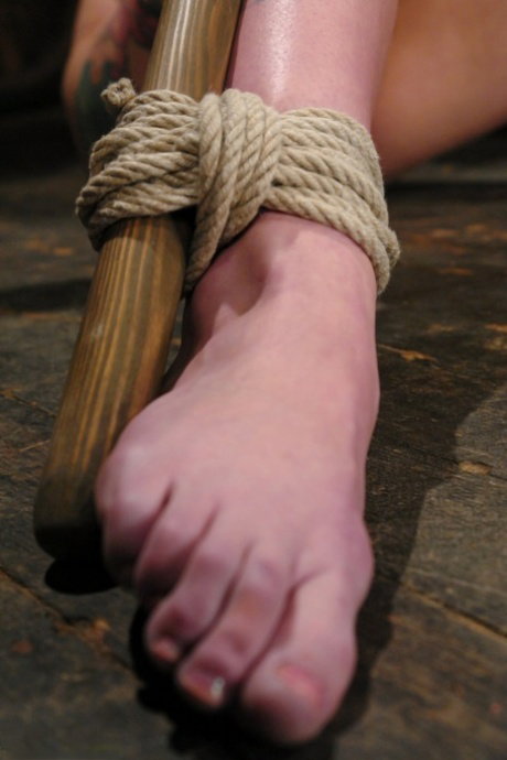 Naked blonde Sarah Jane Ceylon is masturbated while hogtied in a barn
