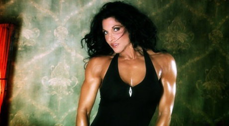 Dark haired bodybuilder Tracy Daniels shows her tight ass in upskirt mode