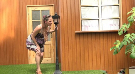 Blonde woman Nicol D hikes short dress to pee standing behind the house