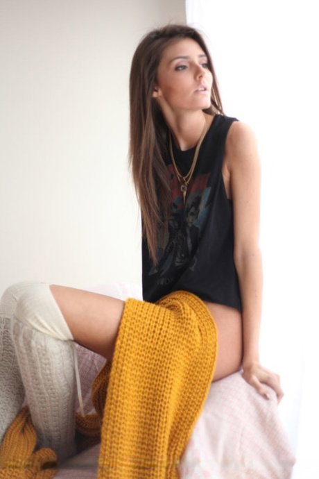 Teen model Sunshine A highlights her bare ass while naked in OTK socks