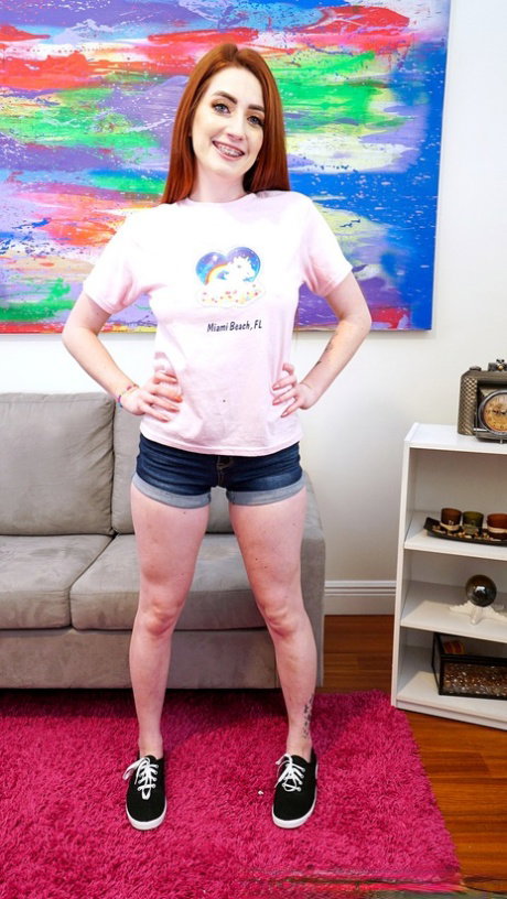 Redheaded caucasian babe Aria Carson sits on a stiff boner on a couch