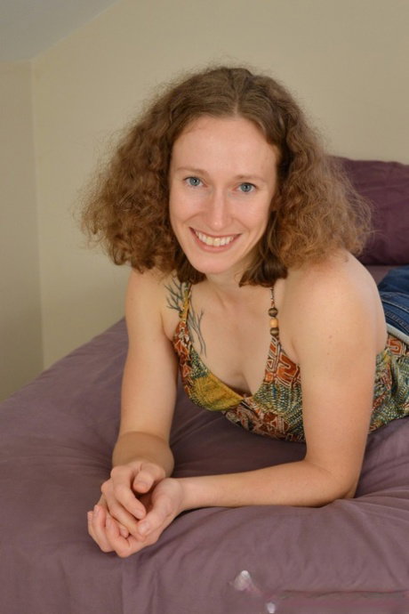 Flexible amateur with curly hair and painted toenails fingers her hairy bush