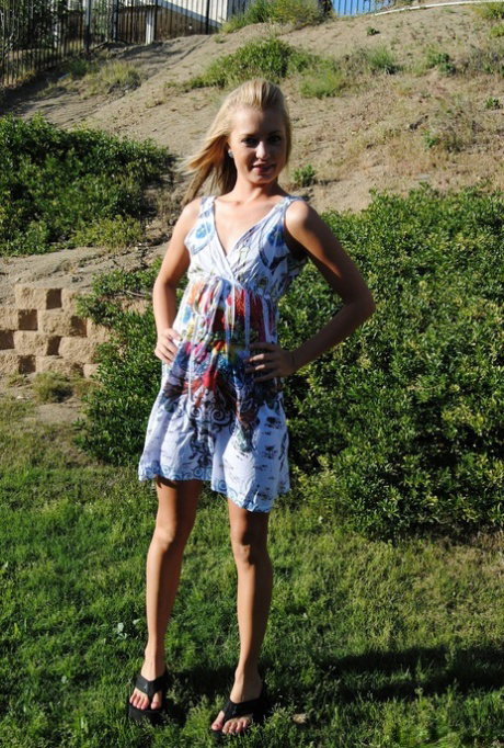 Blonde amateur Tiny Tiff exposes herself in the backyard while wearing a dress