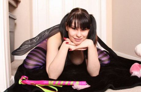 Big titted brunette Susy Rocks teases her pussy in striped thigh highs