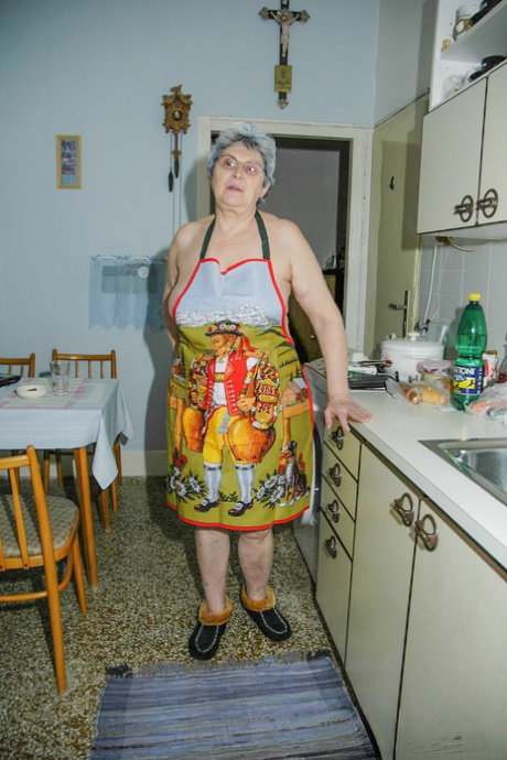 Granny in glasses Rosa reveals her big tits and sticks a cucumber in her bush