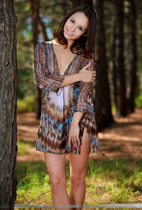Sweet teen with an ass to die for disrobes for great nude poses in a forest