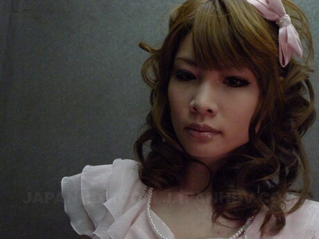 Japanese redhead Shiori Amano gives a blowjob while wearing a black dress