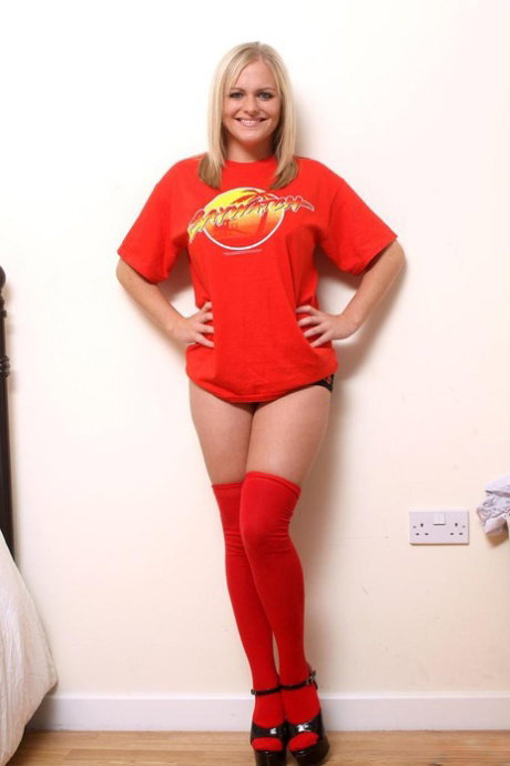 Young blonde plumper plays with her big natural boobs in thigh high socks