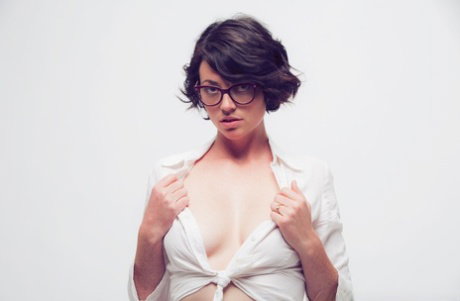Sexy girl Terry Haynes peers over her glasses while showing her tits and pussy