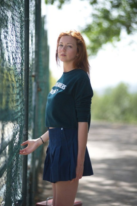 Hot redhead Elen Moore flashes sexy upskirt walking to cheerleader practice