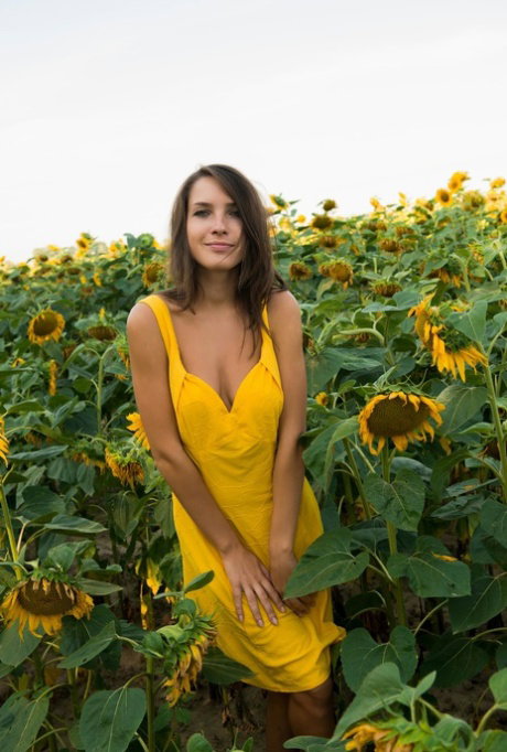 Young beauty Semmi A gets totally naked amid a field of sunflowers