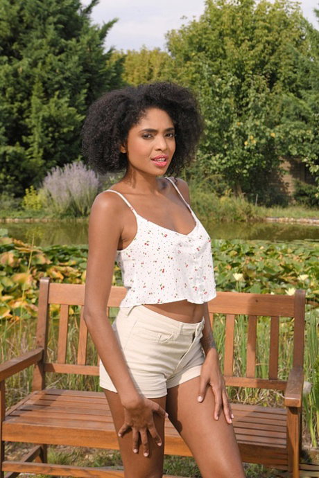 Black girl Luna Corazon spreads her pussy after getting naked on garden bench
