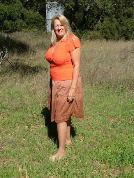 Old amateur Adonna bares her big tits and bald cunt with the sun in her eyes