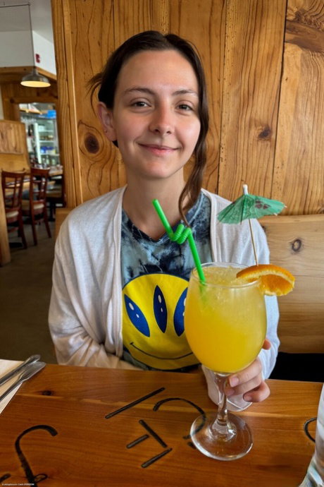 Nice teen Serena Hill takes a tropical drink before her first nude poses