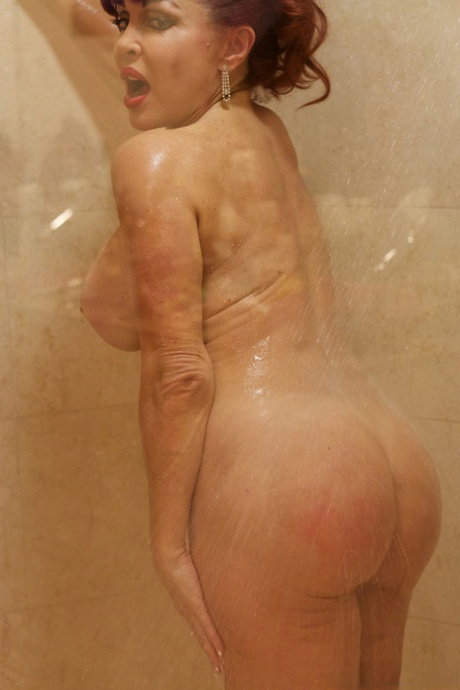 Redhead MILF Sexy Vanessa flaunts her big juggs & round ass while showering