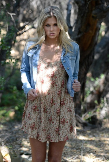 Sultry blonde Scarlet Red removes her dress and rubs her vagina under a tree