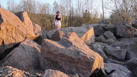 Brunette chick Violet Rilz takes a piss on a pile of rocks