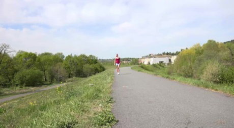 Caucasian girl Amanda Hill pisses on a paved roadway while out for a jog