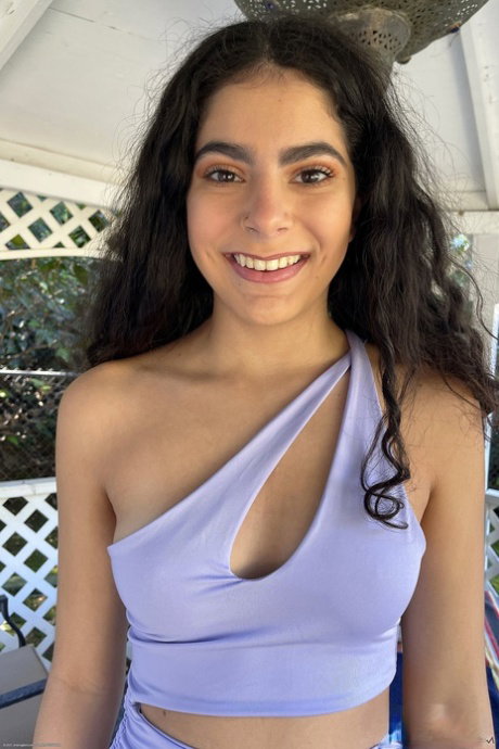 Cute Latina teen Angel Gostosa shows her hairless pussy after going nude