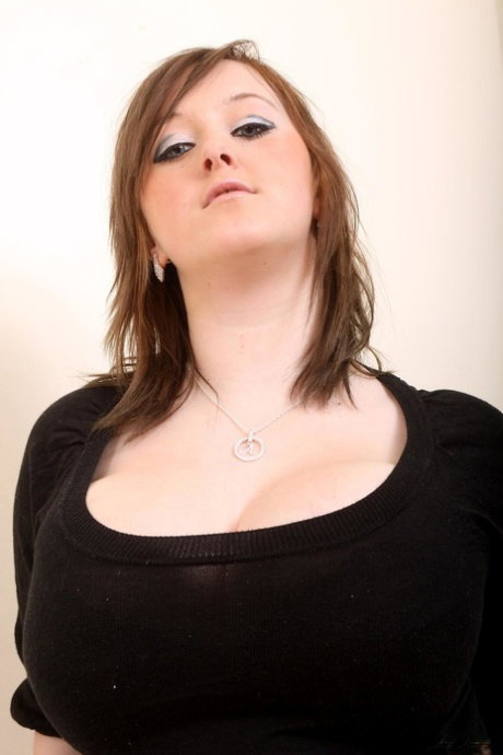 Lusty chubby teen Malibu Candi unleashing her monster melons and posing naked