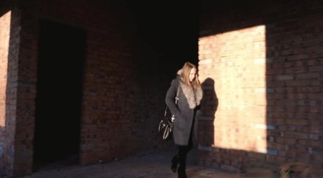 Distressed girl squats for an outdoor piss while wearing a heavy winter coat