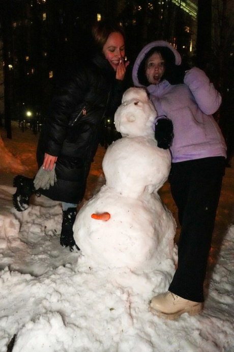 Teen girls make a snowman out in the yard before having lesbian sex