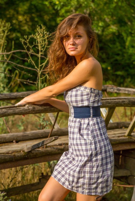 Barely legal girl Furnilla K ditches her dress to model naked on a wagon