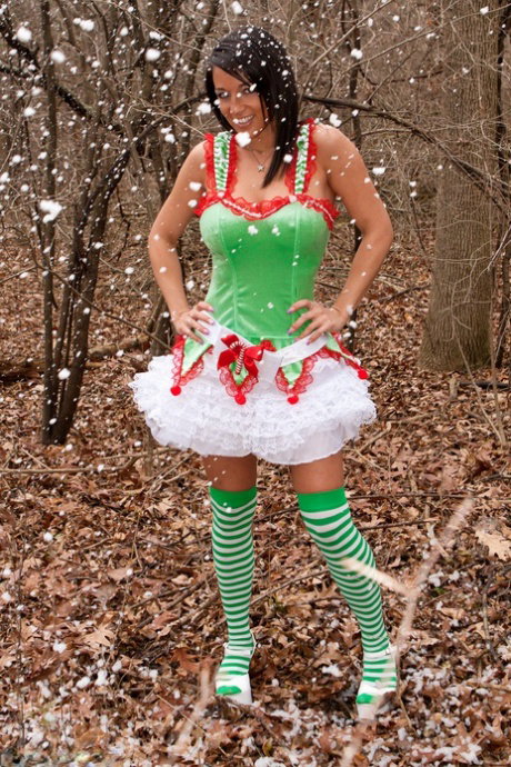 Amateur girl Nikki Sims covers her naked tits in Xmas clothes amid undergrowth