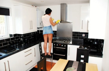 Amateur Raunchy Raven exposes her upskirt panties while cleaning a kitchen