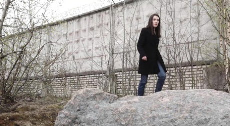 Brunette chick Lara Fox pulls down her jeans to take a piss upon boulders