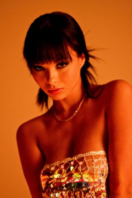 Hot brunette Domino highlights her big boobs while getting totally naked