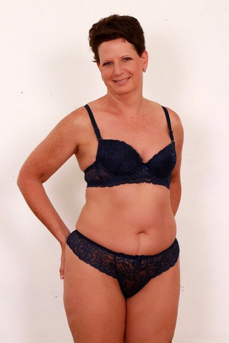 Mature lady Beth Mckenna removes her bra and panty set before giving head