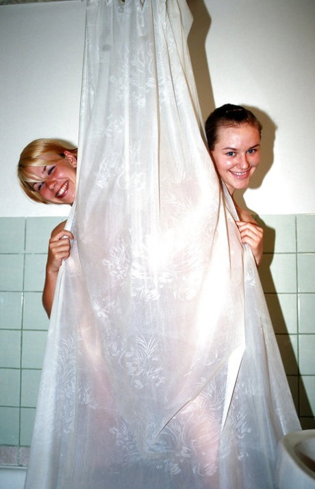 Sweet teenage gals with tiny tits taking a shower together