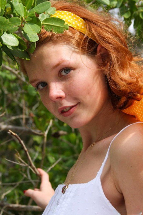 Playful teen Tori C strips completely naked while posing at the beach