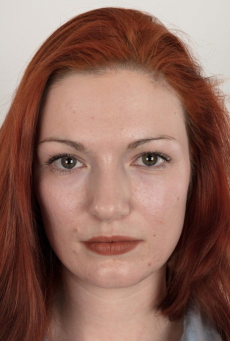 Amateur girl with long red hair takes a seat after standing naked