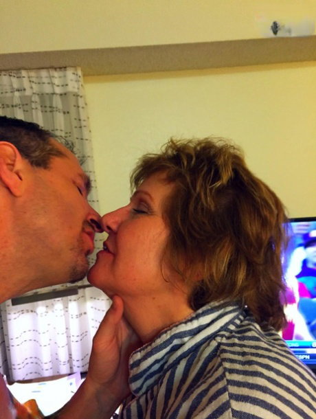 Older woman Busty Bliss sports painted toenails while blowing her toy boy