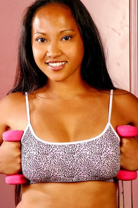 Beautiful Asian babe Loni Camp strips during her workout & shows her big tits