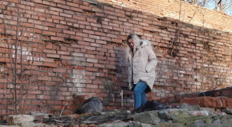 Dirty blonde Masha pulls down her jeans to take an urgent piss near a building