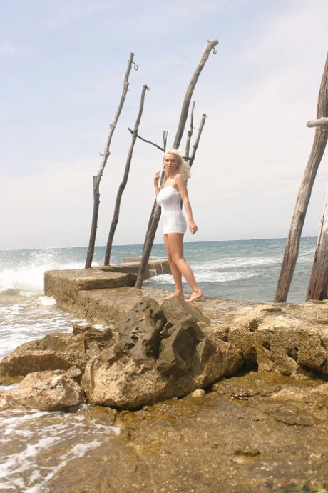 Natural blonde Ines Cudna sports a no panty upskirt before baring her hooters