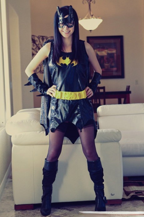 Sweet brunette Catie Minx models cosplay clothing before starting to undress