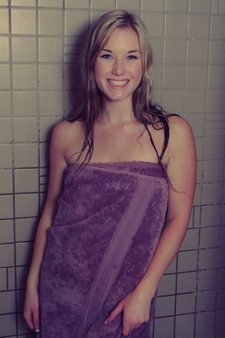 Dirty blonde Jewel removes a bath towel to show her naked body in a shower