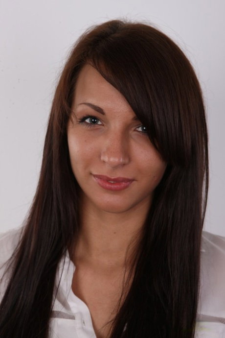Brunette amateur with a hairless pussy stands naked after removing her clothing