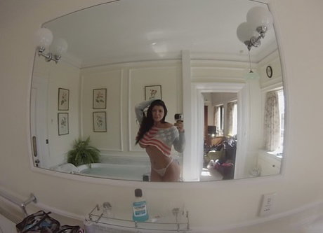 Attractive MILF Romi Rain strips and shows her curves before having a bath