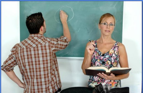 Mature teacher in glasses Nicole Moore pleasuring cock with her boobs