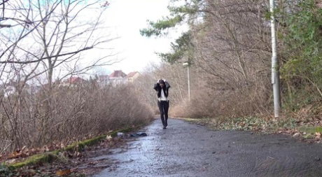 Brunette chick Shalina Shine gets caught taking a piss upon wet pavement