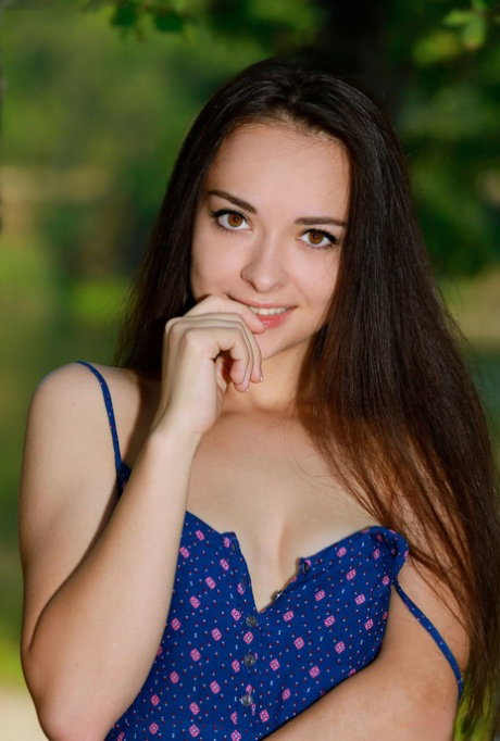 Beautiful brunette teen Chanel C gets naked atop her dress in a forest