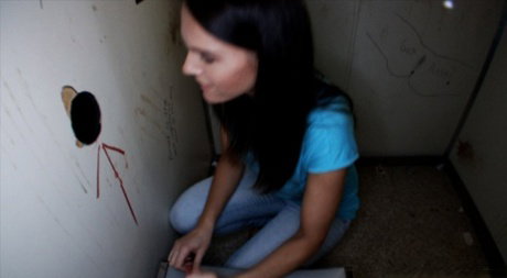 Brunette babe with amazing boobs Jennifer Dark gets banged through a gloryhole