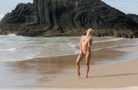 Natural blonde Tracy A poses totally naked on a pristine beach